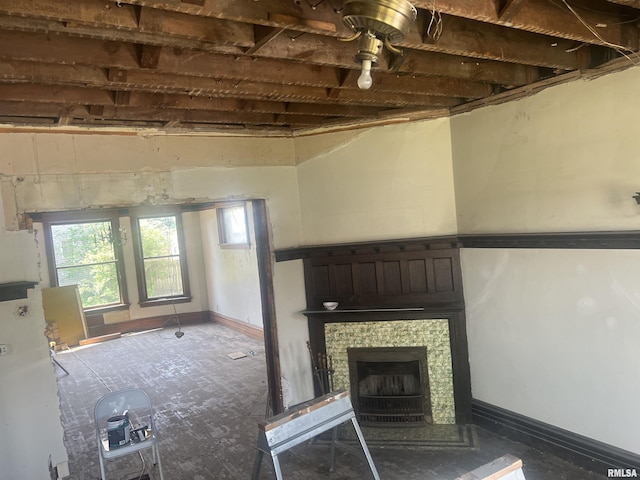 unfurnished living room with plenty of natural light and a fireplace