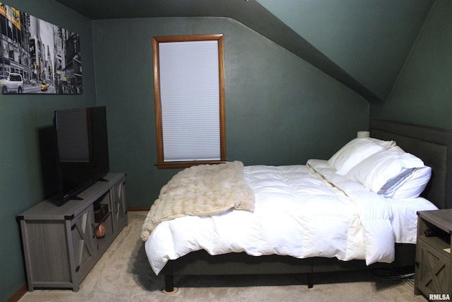 bedroom featuring lofted ceiling and light colored carpet