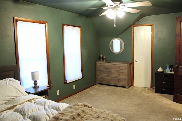 carpeted bedroom with vaulted ceiling and ceiling fan