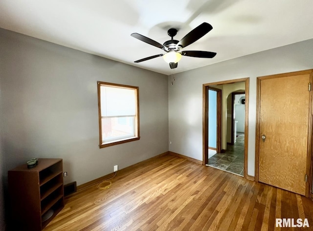 101 N Ridge St, Cambridge, IL 61238 - unfurnished bedroom featuring wood finished floors, baseboards, and ceiling fan