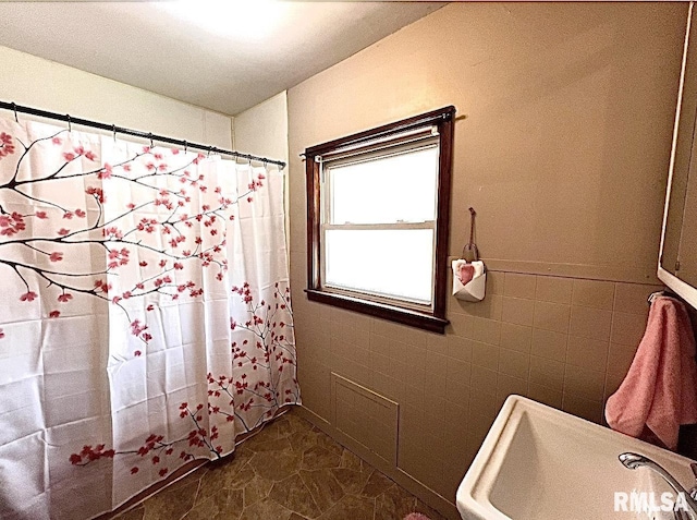 101 N Ridge St, Cambridge, IL 61238 - full bathroom with a shower with shower curtain, a sink, and tile walls