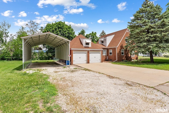 101 N Ridge St, Cambridge, IL 61238 - view of front of property featuring a detached carport, a front lawn, concrete driveway, and a garage