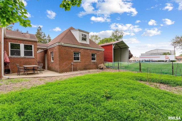 101 N Ridge St, Cambridge, IL 61238 - back of house with a carport and brick siding