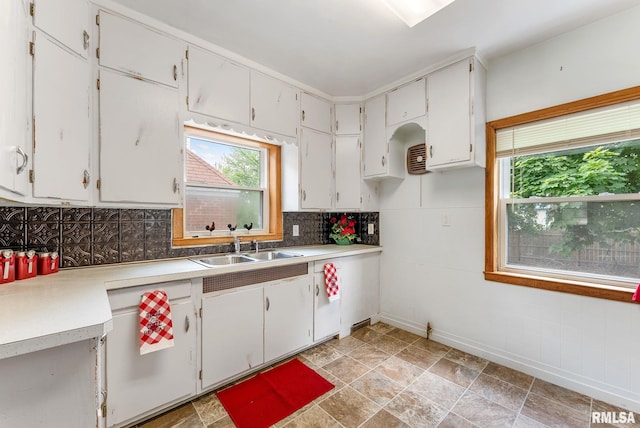 101 N Ridge St, Cambridge, IL 61238 - kitchen with decorative backsplash, a sink, and white cabinets