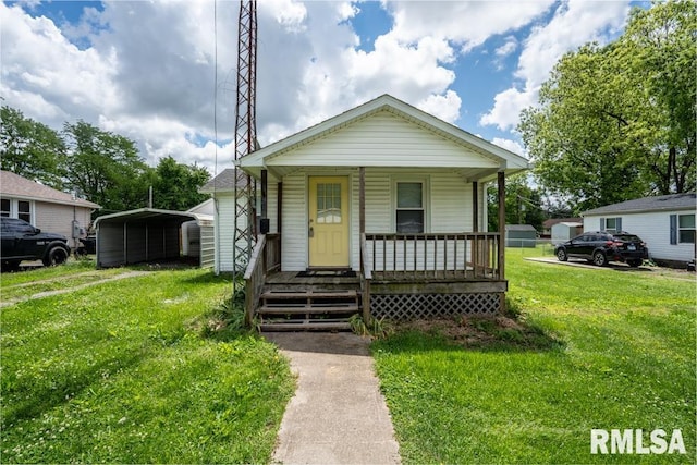 view of front of house with a carport, a porch, and a front yard