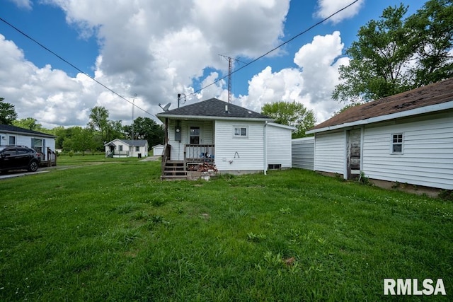 back of property featuring a yard