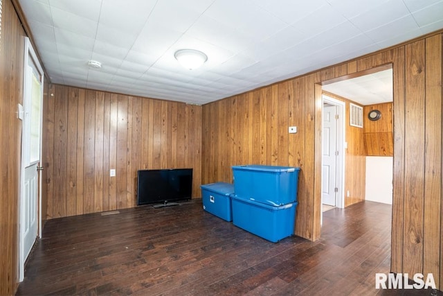 misc room with hardwood / wood-style floors and wooden walls