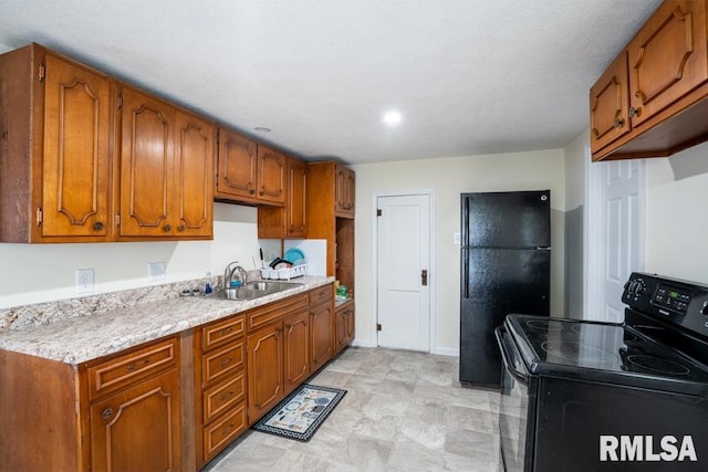 kitchen featuring black appliances, a sink, and brown cabinetry