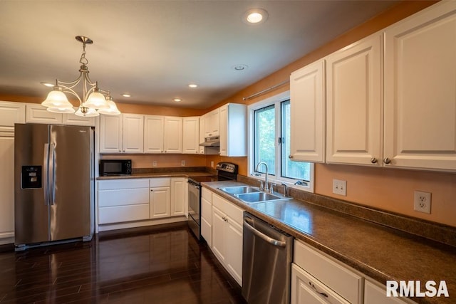 613 N 29th St, Herrin, IL 62948 - kitchen featuring appliances with stainless steel finishes, a sink, under cabinet range hood, recessed lighting, and dark countertops