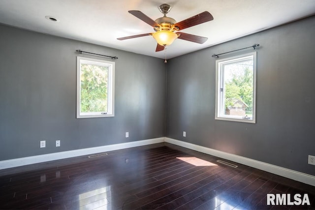 613 N 29th St, Herrin, IL 62948 - empty room featuring plenty of natural light, baseboards, dark wood finished floors, and ceiling fan