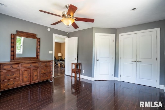 613 N 29th St, Herrin, IL 62948 - bedroom with baseboards, dark wood-type flooring, a closet, and a ceiling fan