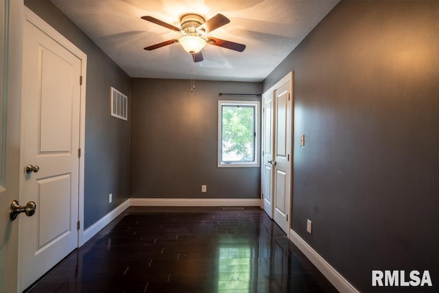 613 N 29th St, Herrin, IL 62948 - unfurnished room with baseboards, dark wood-style flooring, and a ceiling fan