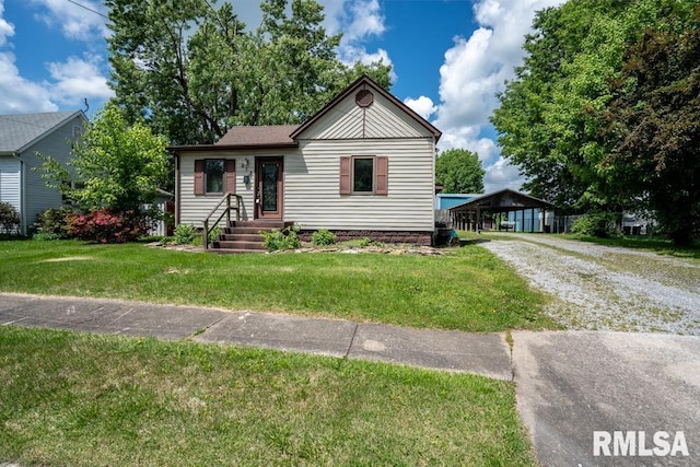 613 N 29th St, Herrin, IL 62948 - view of front of house featuring driveway, a front lawn, and a carport
