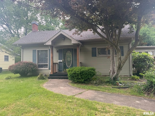 501 N Commercial St, Benton, IL 62812 - bungalow-style house with a front lawn, a chimney, and roof with shingles