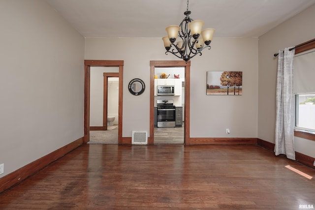 2317 Davie St, Davenport, IA 52804 - spare room featuring wood finished floors, a chandelier, and baseboards
