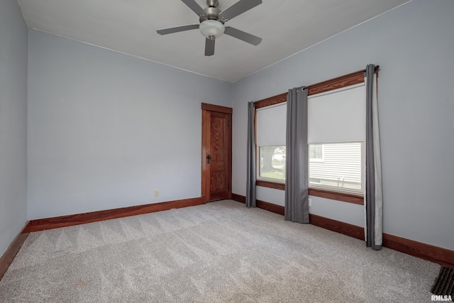 2317 Davie St, Davenport, IA 52804 - empty room with carpet floors, baseboards, and a ceiling fan