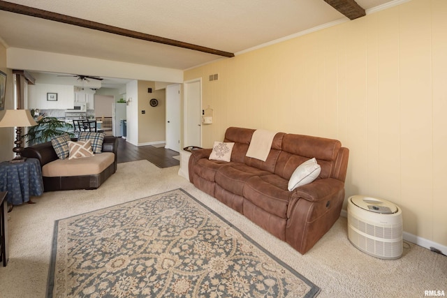 2828 Jersey Ridge Rd, Davenport, IA 52803 - carpeted living room featuring crown molding, baseboards, and beam ceiling