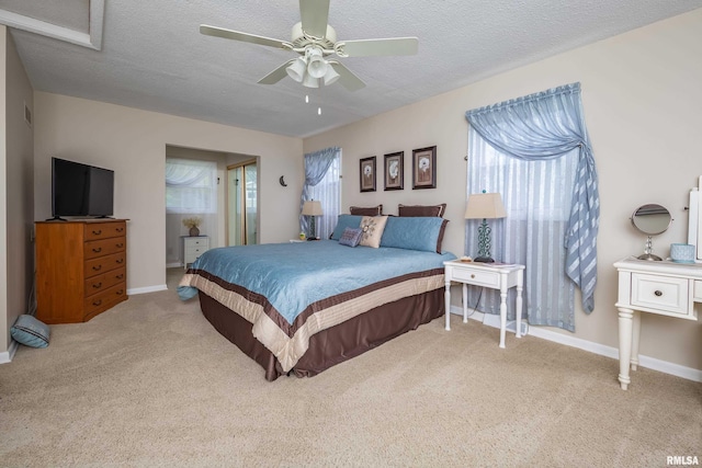 2828 Jersey Ridge Rd, Davenport, IA 52803 - carpeted bedroom featuring multiple windows, a textured ceiling, baseboards, and ceiling fan