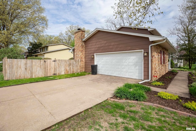 2828 Jersey Ridge Rd, Davenport, IA 52803 - view of home's exterior featuring fence, driveway, and brick siding