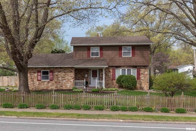 2828 Jersey Ridge Rd, Davenport, IA 52803 - view of front of property with brick siding, covered porch, a shingled roof, a chimney, and a fenced front yard