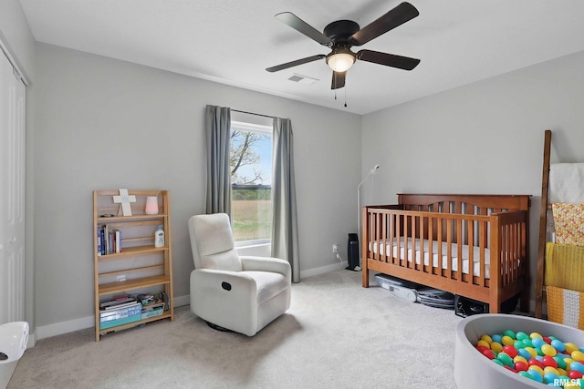 4625 W 11th St, Davenport, IA 52804 - carpeted bedroom featuring a nursery area, baseboards, a closet, and a ceiling fan