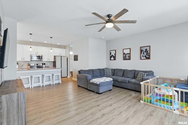 4625 W 11th St, Davenport, IA 52804 - living room with ceiling fan, light wood-style flooring, and recessed lighting