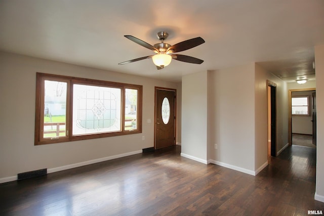 foyer entrance featuring a ceiling fan, dark wood-style flooring, and baseboards