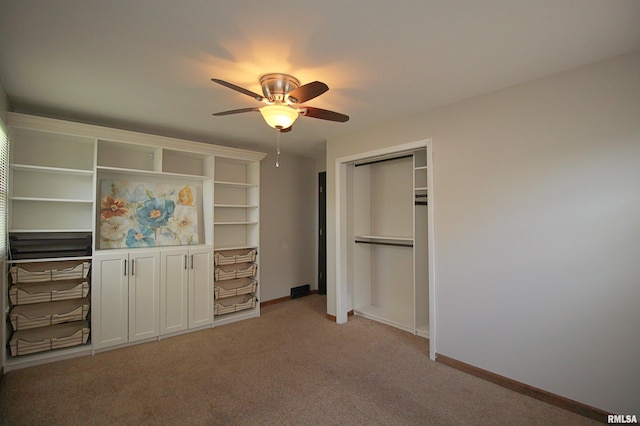 unfurnished bedroom with light carpet, baseboards, and a ceiling fan