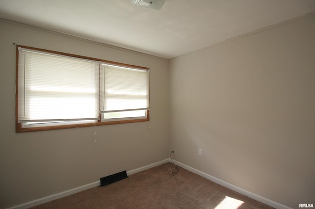 carpeted empty room with baseboards