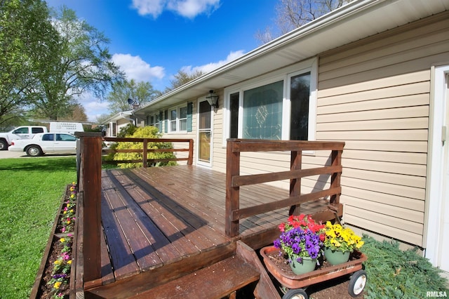 wooden deck with a lawn