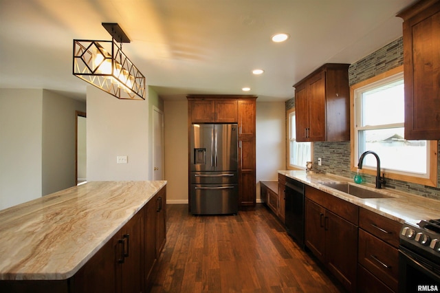 kitchen with black appliances, a sink, dark wood-type flooring, recessed lighting, and light stone counters