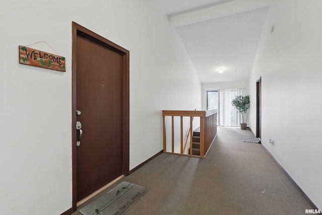 corridor with an upstairs landing, carpet flooring, and baseboards