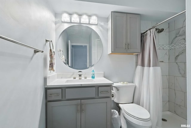 full bathroom featuring a stall shower, toilet, and vanity