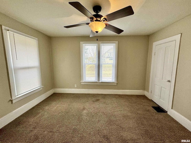 1207 Tremont Ave, Davenport, IA 52803 - unfurnished bedroom featuring dark carpet and baseboards