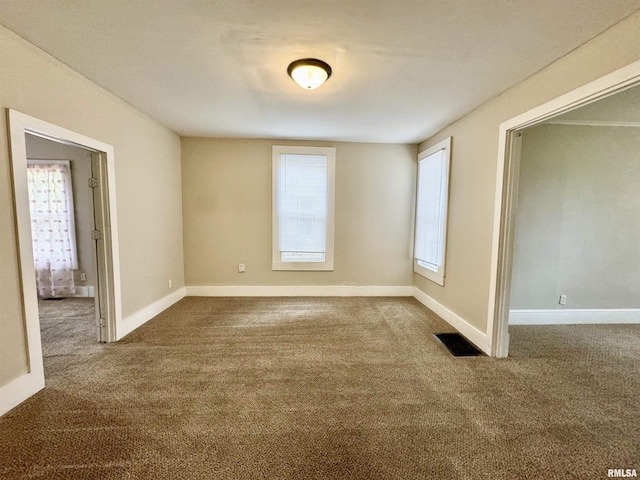 1207 Tremont Ave, Davenport, IA 52803 - empty room with dark colored carpet and baseboards