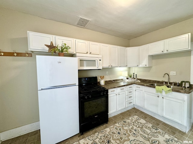 1207 Tremont Ave, Davenport, IA 52803 - kitchen with white appliances, a sink, dark countertops, and white cabinetry