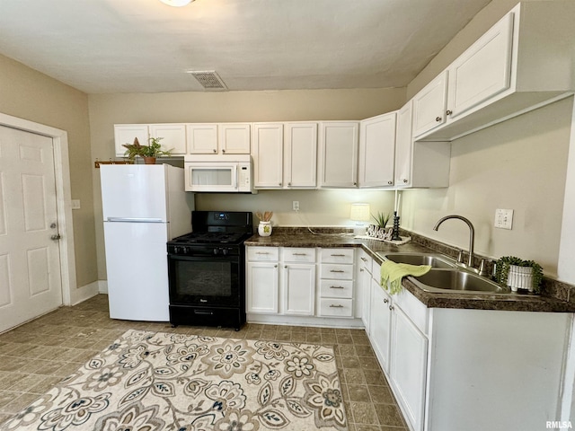 1207 Tremont Ave, Davenport, IA 52803 - kitchen with white appliances, dark countertops, a sink, and white cabinetry