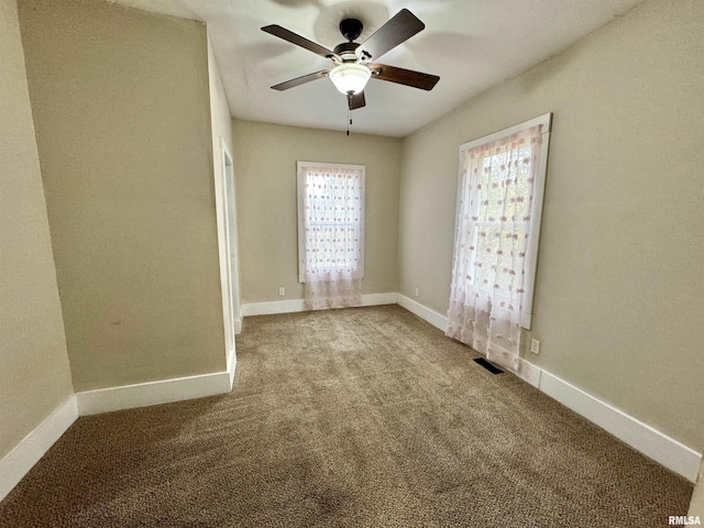 1207 Tremont Ave, Davenport, IA 52803 - carpeted empty room featuring a ceiling fan and baseboards