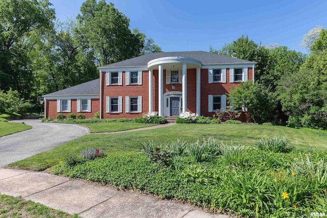 1220 38th Avenue Ct, Rock Island, IL 61201 - neoclassical home featuring a front lawn, asphalt driveway, and brick siding