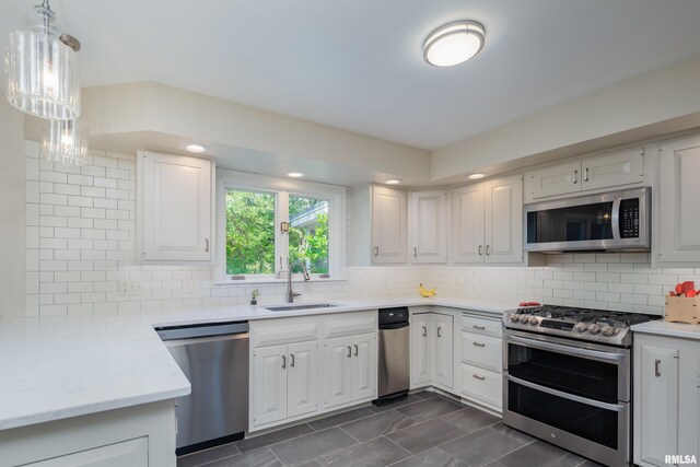 1220 38th Avenue Ct, Rock Island, IL 61201 - kitchen with appliances with stainless steel finishes, a sink, backsplash, and white cabinetry