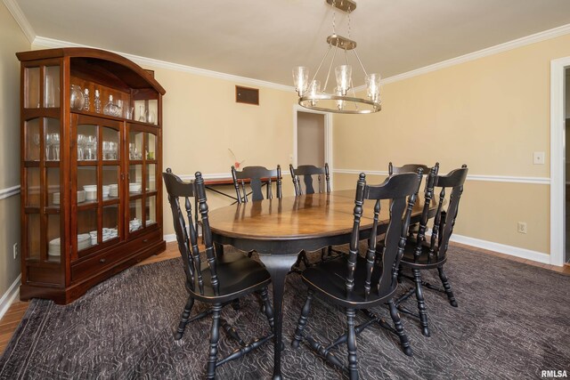 1220 38th Avenue Ct, Rock Island, IL 61201 - dining room featuring ornamental molding, baseboards, a chandelier, and wood finished floors