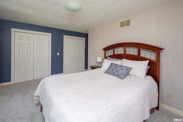 1220 38th Avenue Ct, Rock Island, IL 61201 - bedroom featuring carpet flooring, two closets, and baseboards