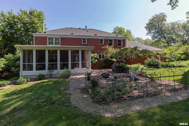 1220 38th Avenue Ct, Rock Island, IL 61201 - back of house with a sunroom, an outdoor fire pit, a patio, and a lawn
