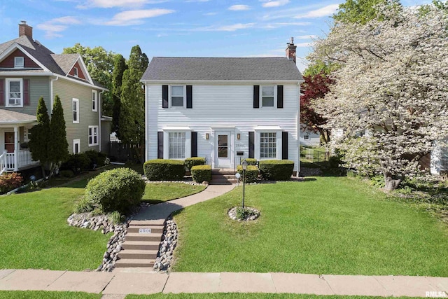 2544 E St, Davenport, IA 52803 - colonial inspired home featuring a front yard and a chimney