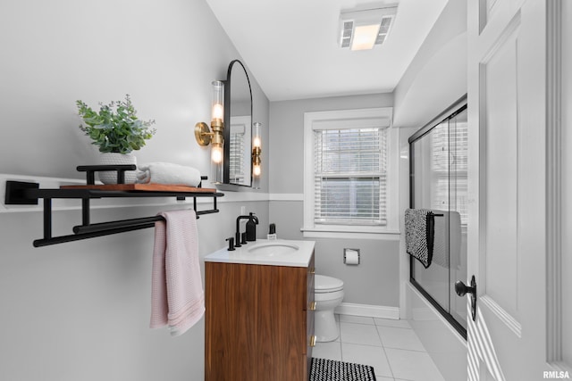 2544 E St, Davenport, IA 52803 - full bath with tile patterned flooring, toilet, shower / bath combination with glass door, vanity, and baseboards