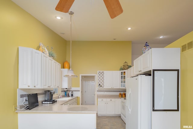 kitchen with white appliances, a sink, a ceiling fan, a peninsula, and recessed lighting