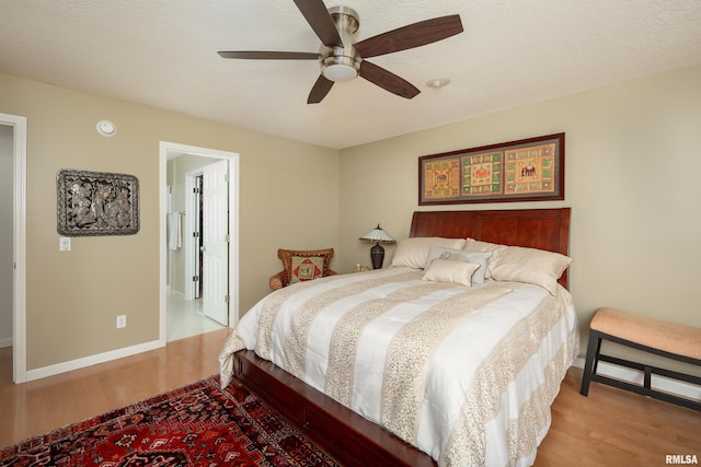 bedroom featuring wood finished floors, baseboards, and ceiling fan