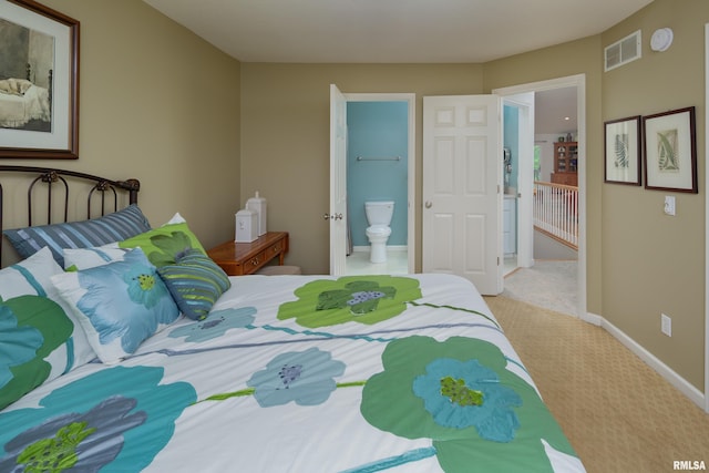 bedroom with carpet floors, baseboards, and ensuite bathroom