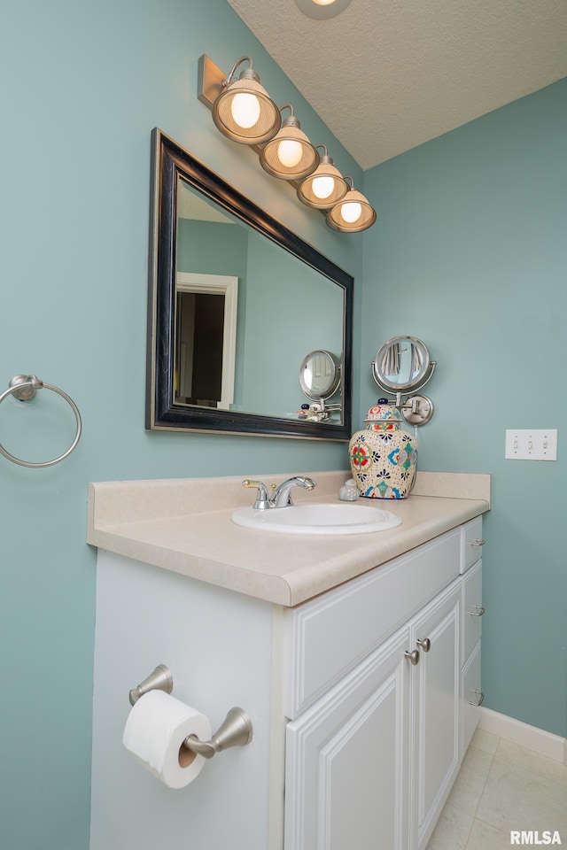 bathroom with vanity, tile patterned flooring, and a textured ceiling