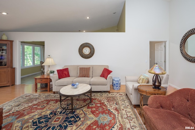 living room featuring baseboards, wood finished floors, and recessed lighting